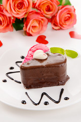 Sweet cake with chocolate on plate close-up