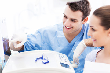 Dentist showing x-rays to patient