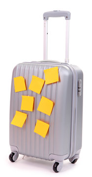 Suitcase with paper stickers isolated on white