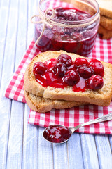 Delicious toast with jam on table close-up