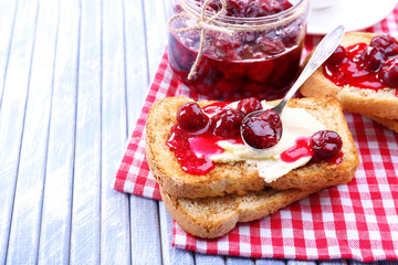 Delicious toast with jam on table close-up