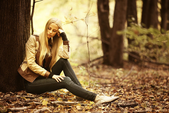 beautiful young girl in the autumn forest