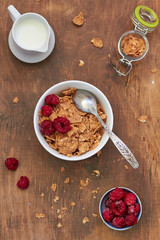 Healthy breakfast: cornflakes with milk and raspberries