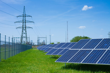 solar panel against high voltage tower