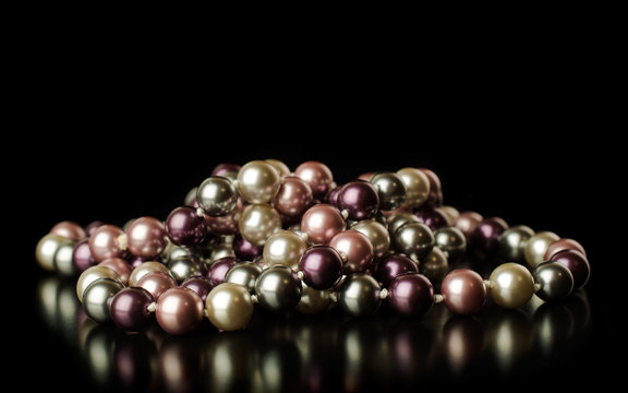 colored pearls on a black background