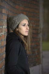 sad young woman with knitted hat