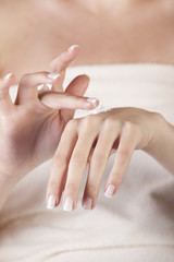 female applying cream on her hands