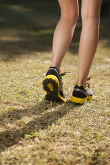 running or walking in nature,legs in sneakers