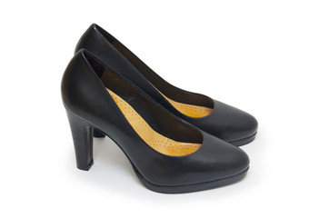 Close-up of female high-heeled shoes over white background