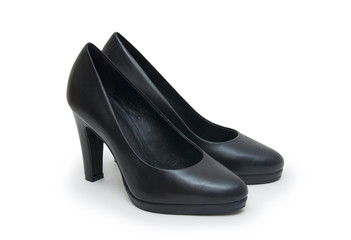 Close-up of female high-heeled shoes over white background