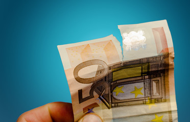 torn euro banknote