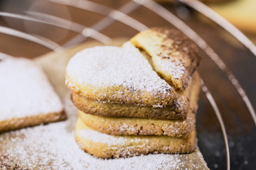 Shortbread cookies in shape of heart on a cooling rack
