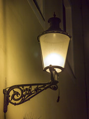Beautiful, decorated lantern attached to the wal of an old house © greir