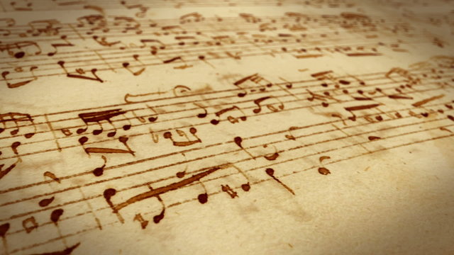 Dolly shot of a old musical note paper sheet