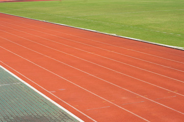 Obraz premium Orange racecourse with white line and green yard