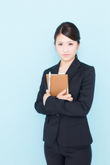 Naklejka premium young asian businesswoman on blue background