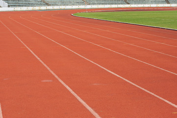 Obraz premium Orange racecourse with white line and green yard