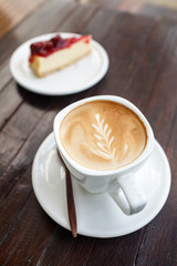 Cup of latte coffee with cake