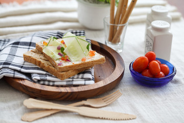 Freshly made sanwich on wooden cutting board