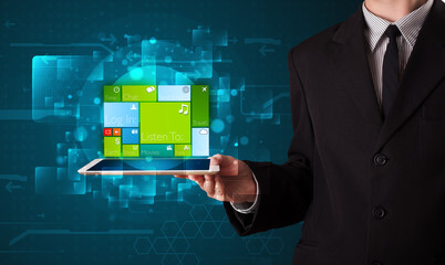 Businessman holding a tablet with modern software operational sy