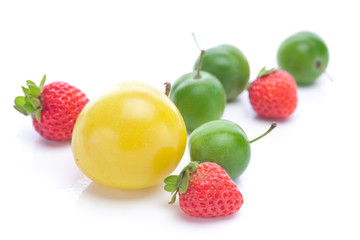 Fototapeta na wymiar green and yellow plums and strawberries isolated on white