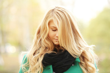 face portrait of a beautiful blonde in autumn winter coat