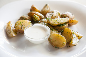 baked potatoes and dill with selective focus