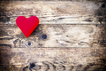 Wood background with red heart and nothing else.