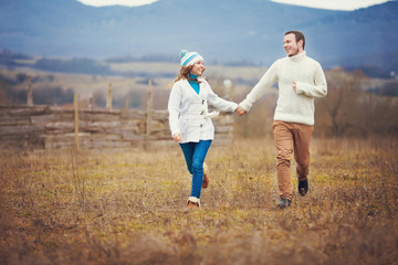 Young couple walking together while enjoying a day in park