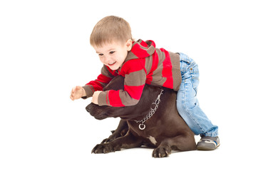 Child playing with dog closes her eyes
