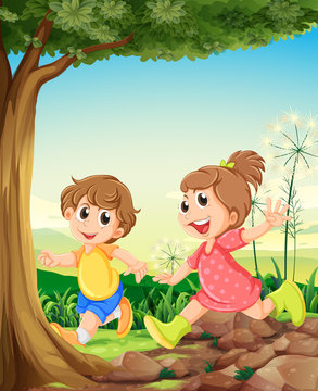 Two adorable kids playing under the tree