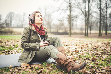 beautiful brunette woman listening to music with headphones