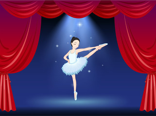 A ballerina at the stage with a red curtain
