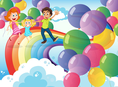 A happy family playing with the rainbow and the floating balloon