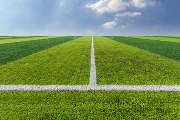 Obraz premium Green Grass Texture in Soccer Field with Sky.