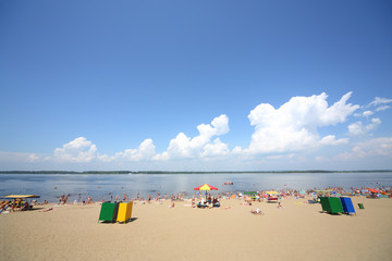 Vacationers sunbathe on the sandy beach