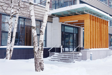 Stoop of modern building decorated with wooden panels