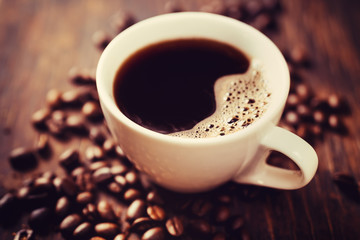 coffee cup and beans, on wooden table