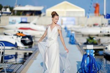 Fototapeta na wymiar Beautiful bride posing in a harbor