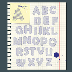 Ink letters of the alphabet on notebook paper.