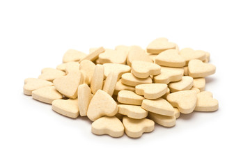 Heap of Heart-shaped tablets isolated on white