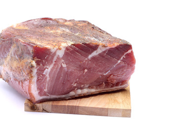 Italian speck on wooden chopping board