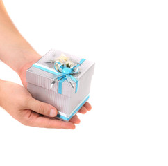 Stylish gift box with blue ribbon in hand.