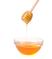 Wooden spoon on bowl with honey.