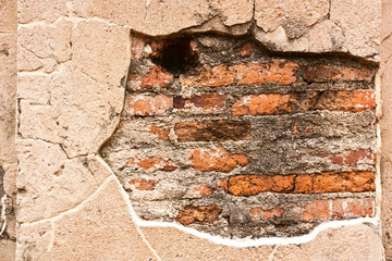 Fototapeta premium Surface mortar on the wall, revealing a red brick.