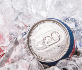 A can of cola drinks with ice cubes