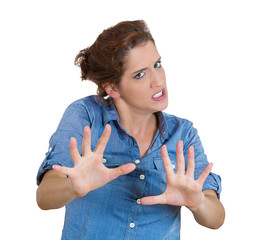Portrait mad young woman raising hands up to say stop