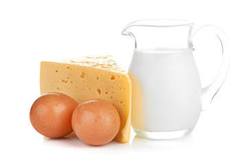 Big piece of cheese, glass jug with milk