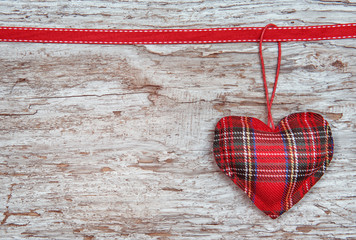 Valentine card with textile heart on old wood