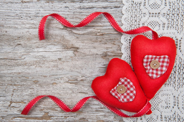 Valentine card with textile hearts on lace and old wood